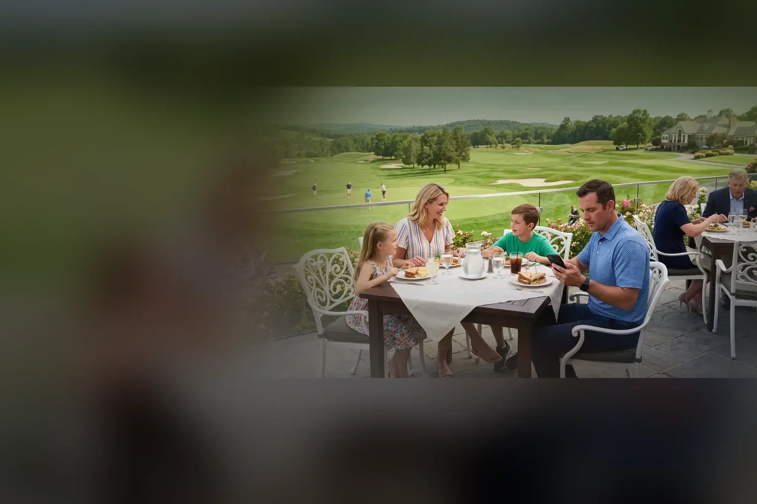 A family at lunch on the clubhouse terrace, the course beyond — where Seven X keeps every member known