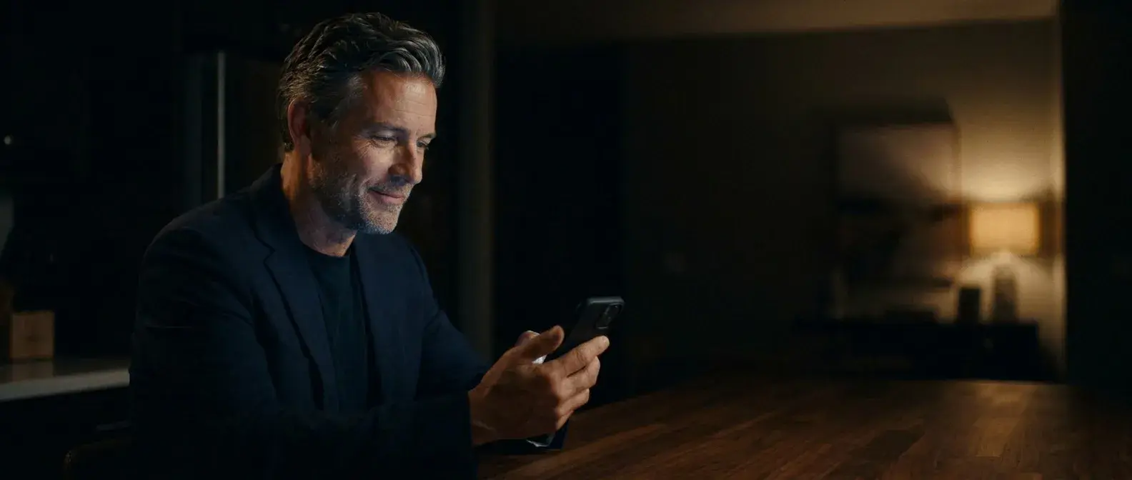 Alex at home in the evening, reading a message from Seven