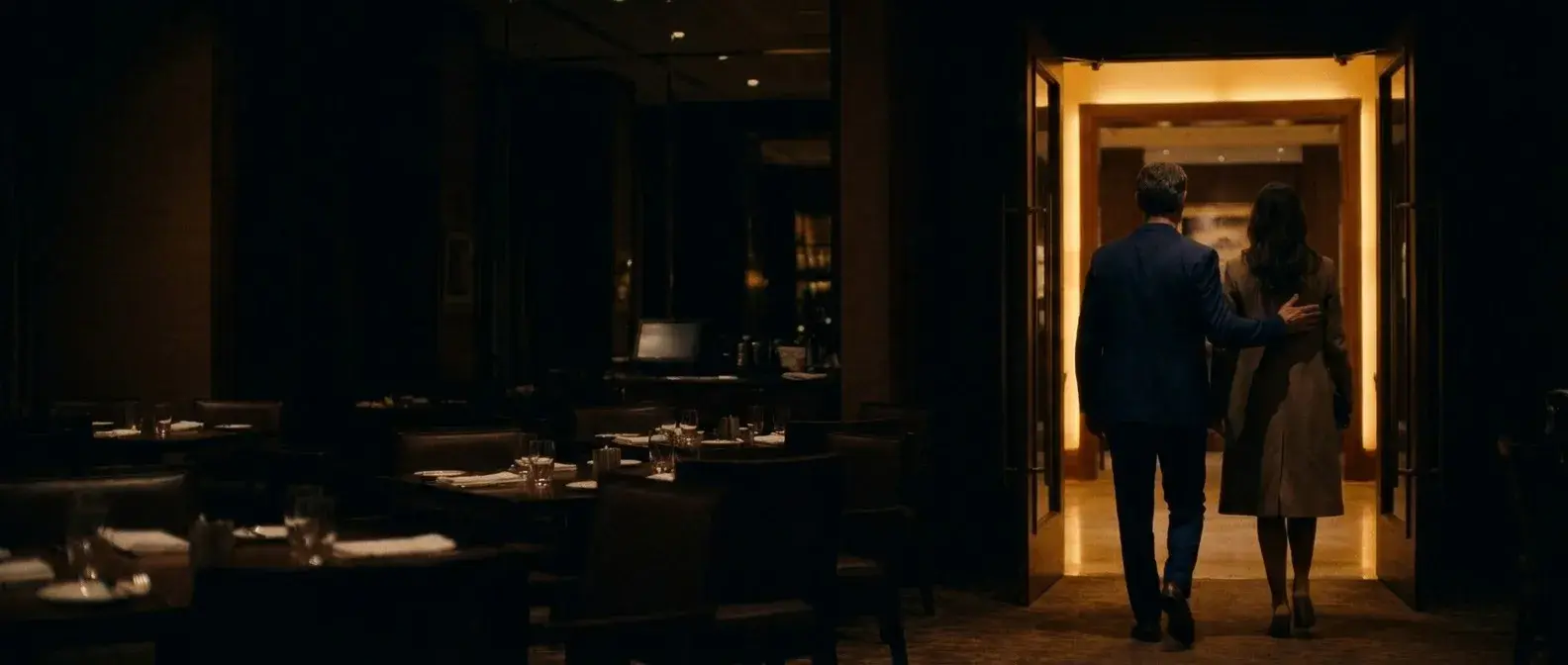 The couple leaving through a warm doorway