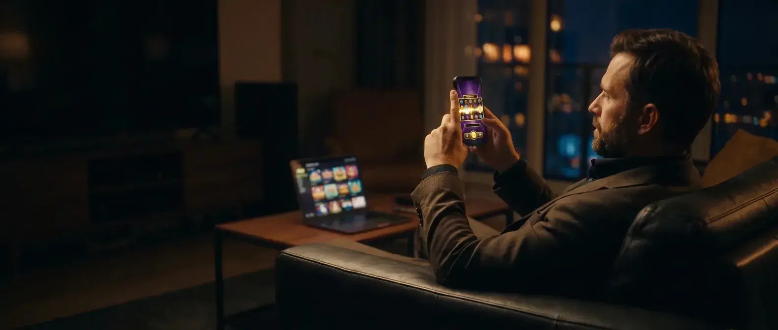 A premium player at home in the evening, an online slot game open on his phone